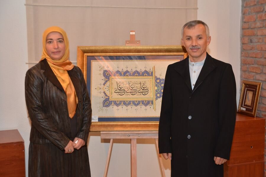Aysel Toprak with her work at an exhibition